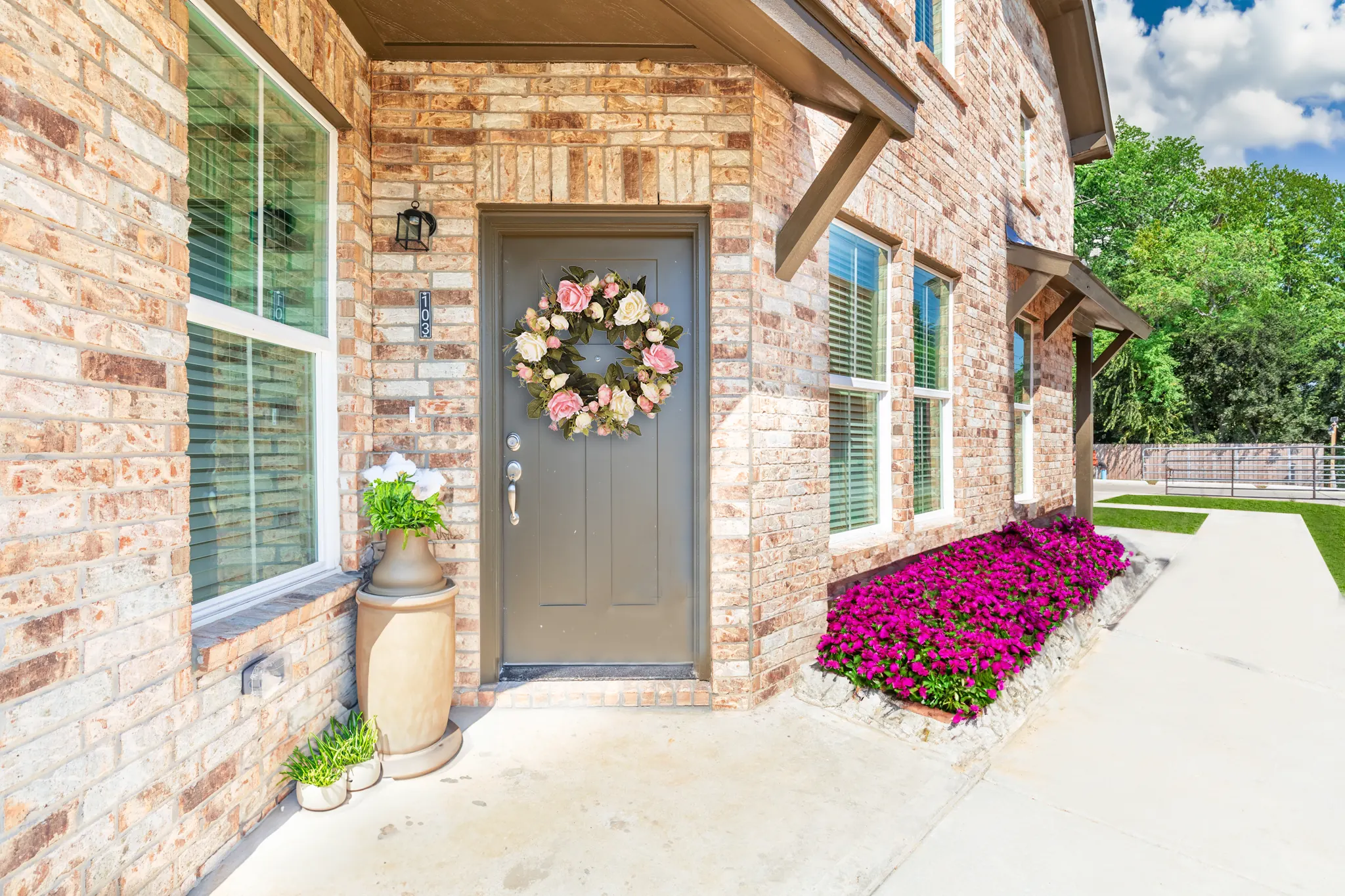 Park Place Flats brick exterior front door with landscaping